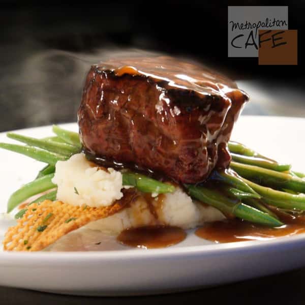 Filet mignon steak on stop of green beans and mashed potatoes