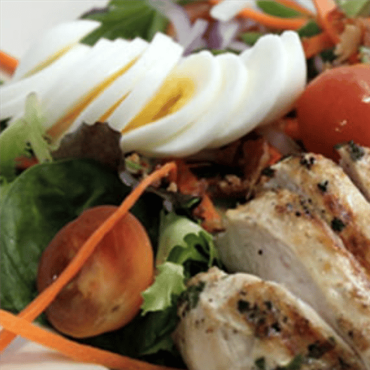 Grilled chicken salad with sliced boiled eggs
