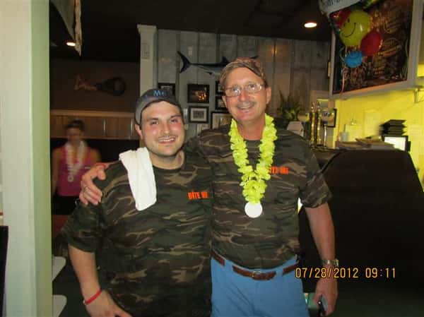 Workers smiling by the front of the restaurant