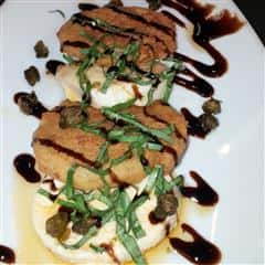 menu item with mozzarella and balsamic dressing drizzled on top