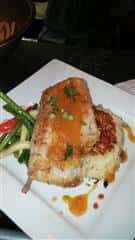 fried seafood on a bed of grilled vegetables