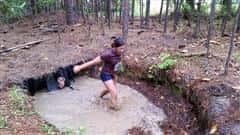 girl in a mud puddle competing mud run 2015 course