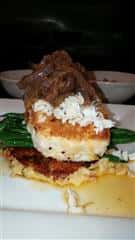 fried menu item on a bed of green beans