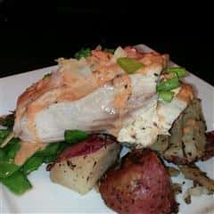 Seafood menu iems on a bed of grilled green beans and red potatoes