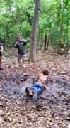 People competing mud run 2015 course in the mud in the woods