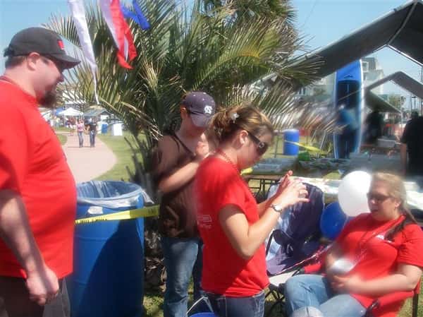 a couple of people working next to the fish bites station