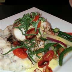 Menu items with mashed potatoes, green beans and tomatoes