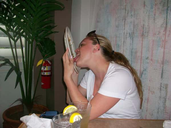 a lady licking her plate clean