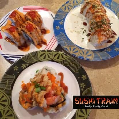 Sushi rolls served with dipping sauce on two plates