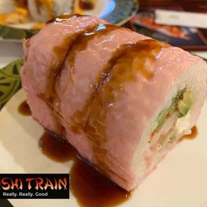 Seared tuna wrapped roll served with wasabi and pickled ginger