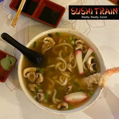 Bowl of noodle soup with fish cake and vegetables