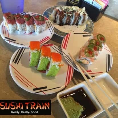 Assortment of colorful sushi rolls arranged on serving trays