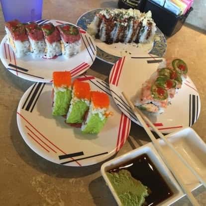 Assorted sushi rolls served with soy sauce for dipping