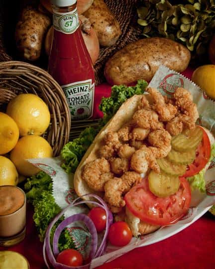 popcorn shrimp poboy with tomatoes, pickles and lettuce