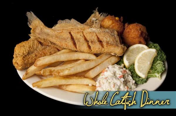 whole catfish dinner with french fries and hush puppies