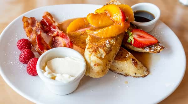 Peach French toast brunch plate with cream and berries at Local on North in Canton and Marietta GA