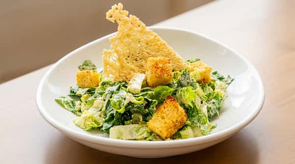Fresh Caesar salad with crisp greens and shaved cheese at Local on North, an elevated American restaurant in Georgia