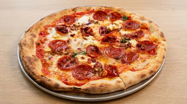 Pepperoni pizza with melted cheese and crispy crust at Local on North, a modern neighborhood restaurant in Georgia