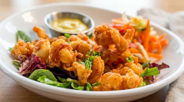 Fried shrimp salad with fresh greens and vegetables at Local on North, a Southern-inspired seafood restaurant in GA