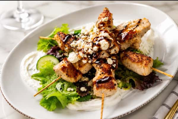 Grilled chicken brochette over fresh mixed greens with feta cheese, balsamic glaze, and seasonal vegetables at Local on North, offering elevated Southern dining in Canton and Marietta.