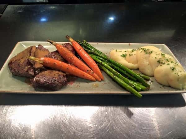 Steak with carrots, asparagus, and whipped potatoes