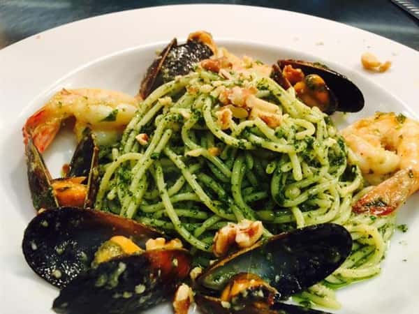 spaghetti with mussels and shrimp in a pesto sauce
