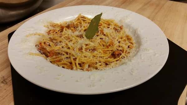 spaghetti dish with bay leaf on top