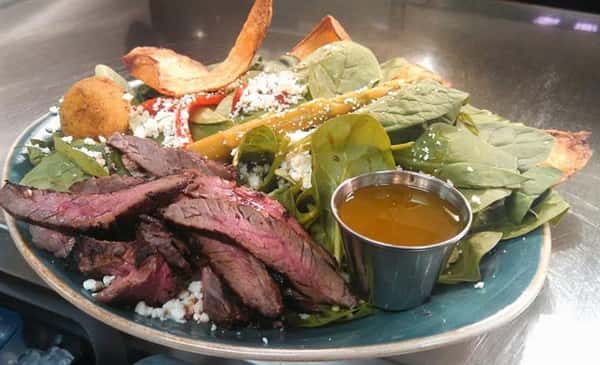 Salad with steak and dressing