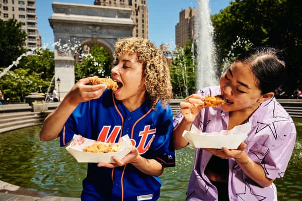 young people enjoying crispy chicken