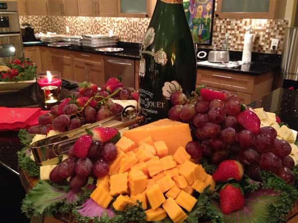 bottle of wine with grapes and cheese