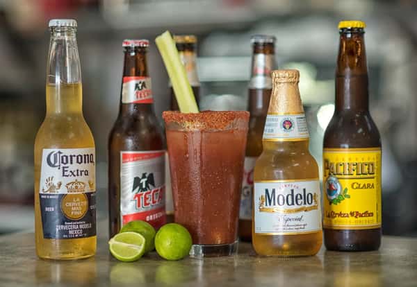 Michelada served alongside a selection of Mexican beers.