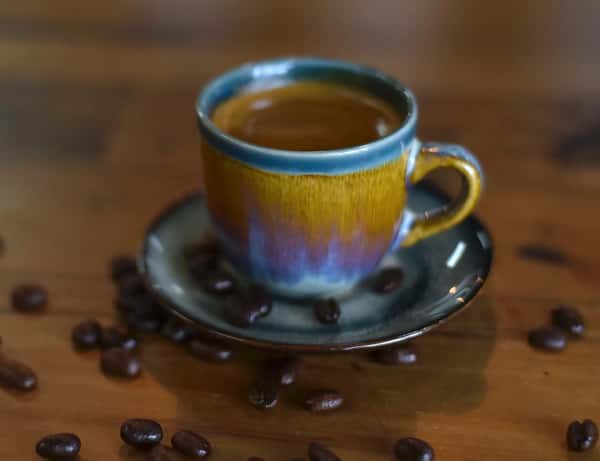 Freshly brewed coffee served in a colorful ceramic mug.