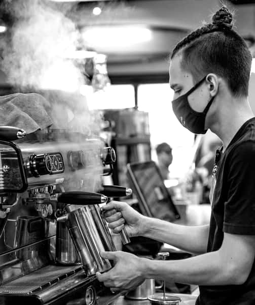 A man making some coffee with a coffee machine