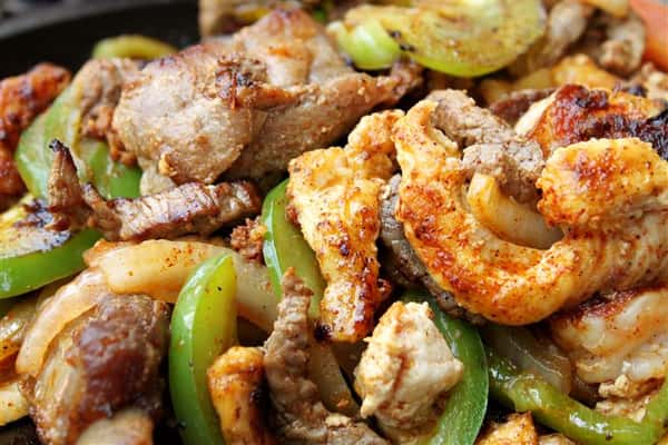 Chicken fajita with green peppers and onions in a skillet
