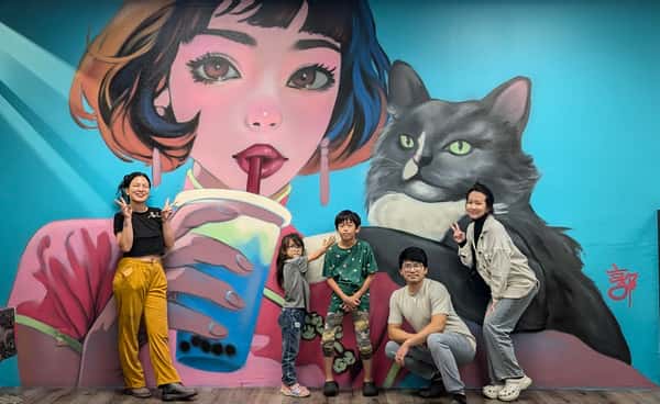 Group photo in front of mural