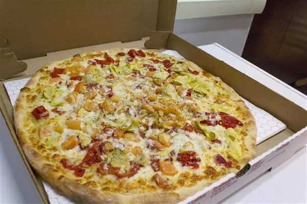 Charlie Chenault Pizza pie. Diced tomatoes, fresh mozzarella, artichoke hearts, roasted red peppers with olive oil and garlic, no sauce!