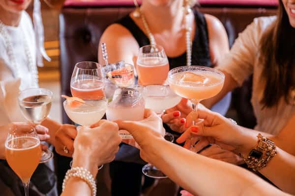 Group of friend cheering cocktail glasses