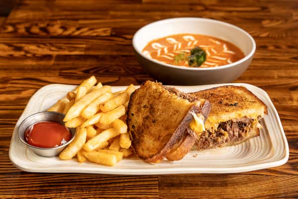 Rich, slow-braised short rib sandwiched between thick slices of crispy bread, loaded with cheddar and pepper jack cheese. Served with a velvety tomato soup for the perfect dunk.