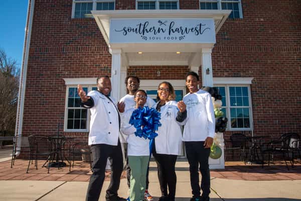 Owners in front of Southern Harvest location