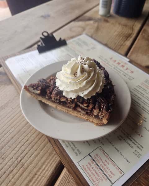 Have you tried our Homemade Pecan Pie yet? 🥧 With its rich, buttery crust, sweet gooey filling of brown sugar and syrup, and toasted pecans for a delicious crunch, Homemade Pecan Pie is a treat worth saving room for.
It's served with squirty cream, or you can choose to add clotted cream or Dann's vanilla ice cream for an extra-indulgent finish 😊 We'd love to welcome you in soon.
#Homemade #Desserts #PecanPie #PlacesToEatWroxham #HovetonAndWroxham #FoodOnTheNorfolkBroads