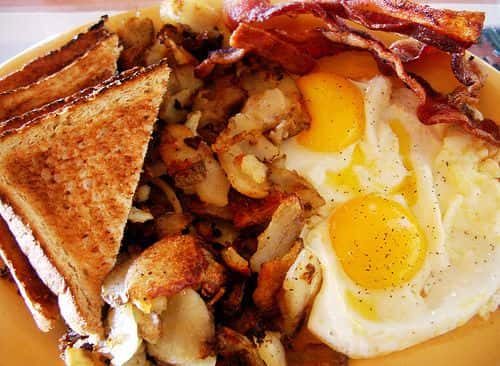 2 French Toast with 2 Eggs, Bacon, & Home Fries