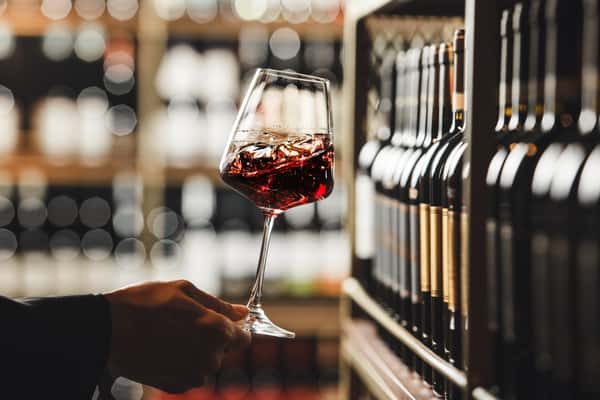 Close-Up-View-of-Person-Swirling-Red-Wine-in-Cellar-Atmosphere-2166045624_4948x3299.jpeg