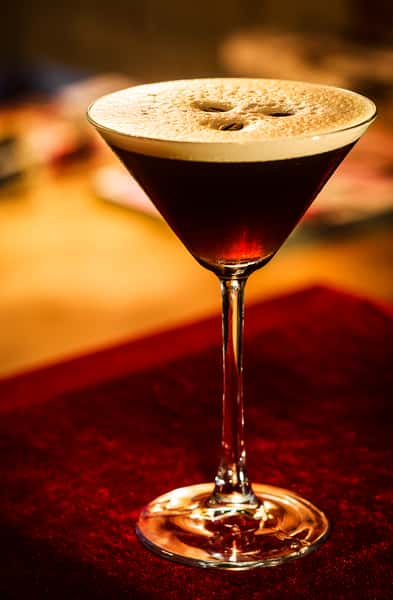 coffee-espresso-cream-martini-cocktail-drink-glass-inside-cozy-bar-
