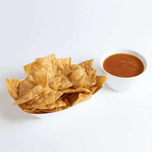 Freshly fried tortilla chips served in a paper tray alongside a small bowl of red salsa, perfect for a classic Mexican appetizer.