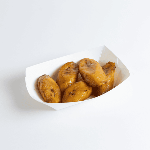 Golden fried sweet plantains served in a white paper tray, showcasing a popular Latin side dish with caramelized edges and a soft interior.