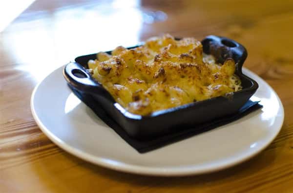 Five cheese Mac. Morbier, Asiago, Gorgonzola, Cheddar and Jack, Smoked Bacon, Roasted Onions & Parmesan Crunchies.