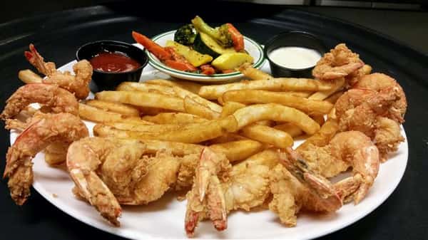 Fried shrimp, fries, side of ketchup and tartar sauce and a small bowl of mixed vegetables