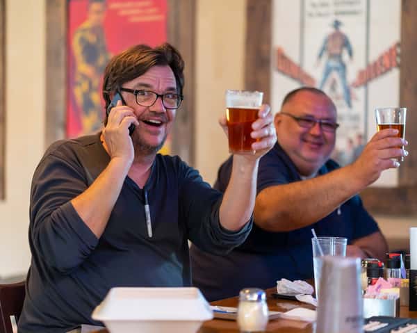 Team members enjoying a drink in a happy space