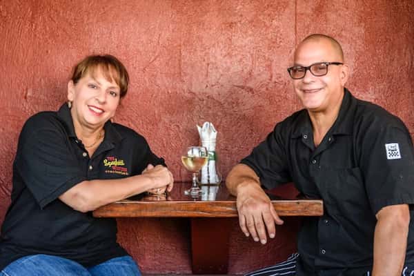 Owners of restaurant posing for a photo