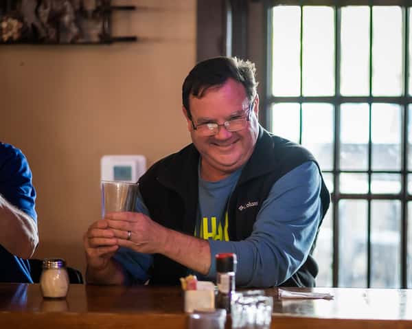 Person laughing at the bar